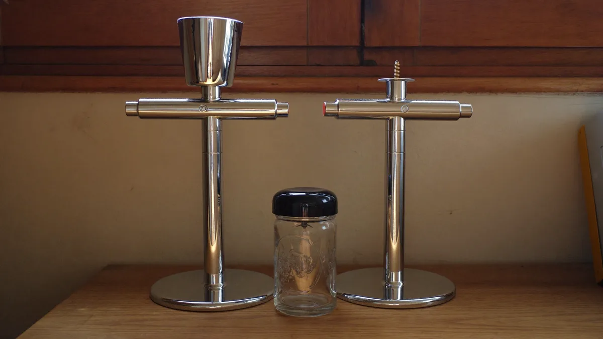 Airbrushes compared on a workbench