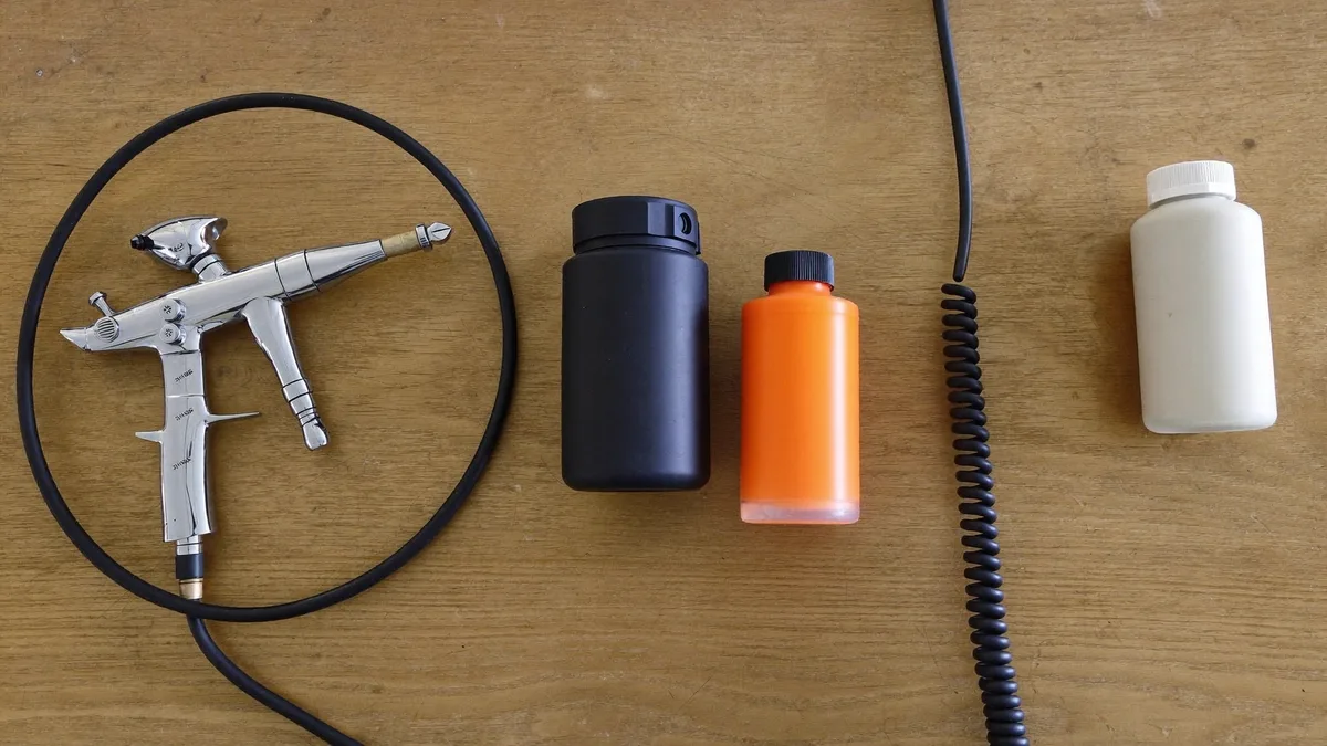 Airbrush starter kit laid out on a workbench